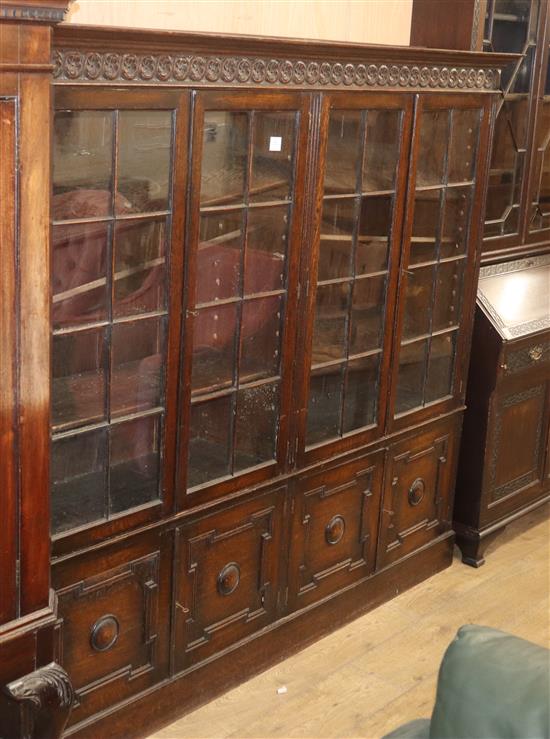 A 1920s oak four door bookcase W.190.5cm